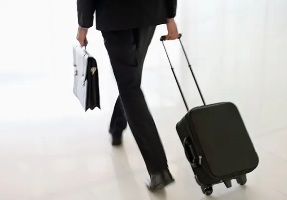A man walking with the suit case